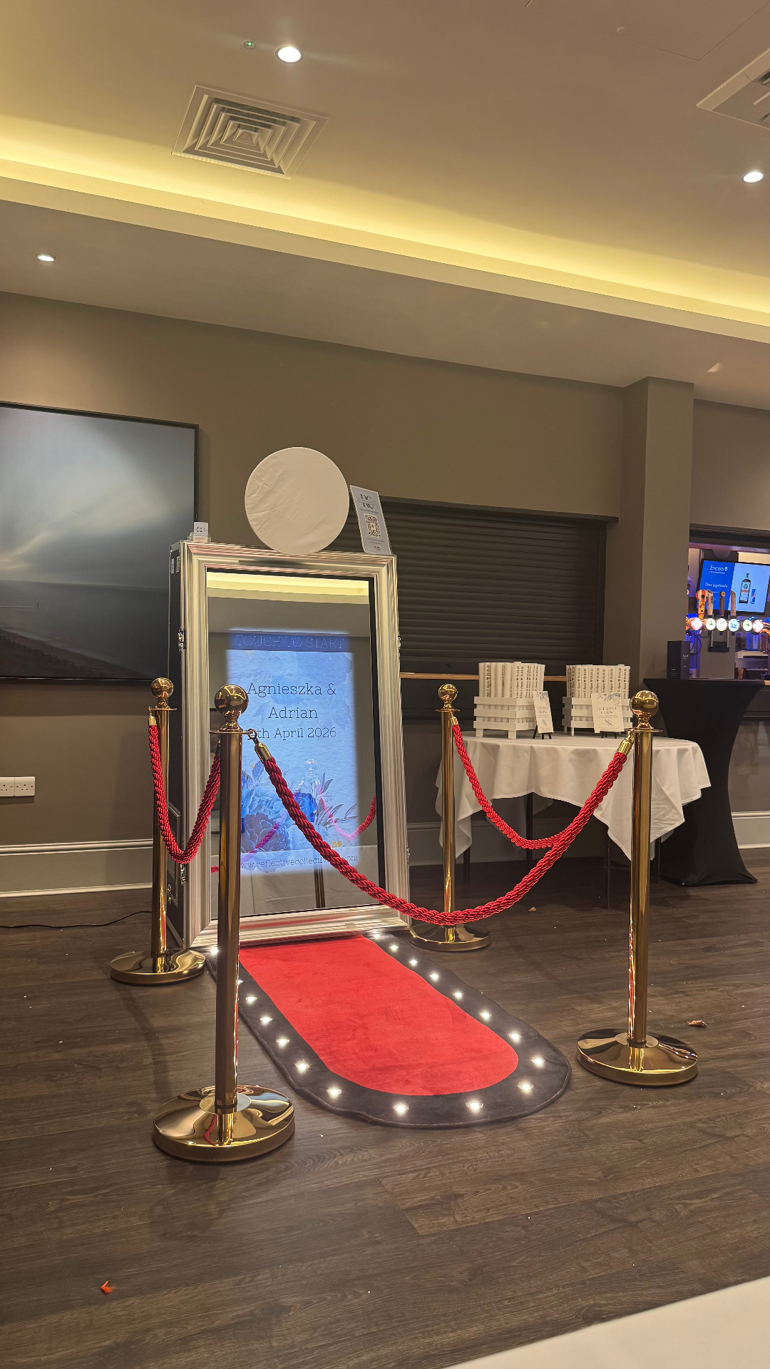 Mirror booth set up at a wedding with a custom start screen for Agnieszka & Adrian